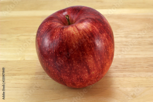 Red gala apple on board
