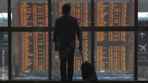 Passenger at airport timetable departure flights gate