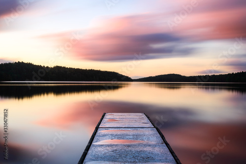 Jetty into lake at sunrise. Gothenburg, Sweden