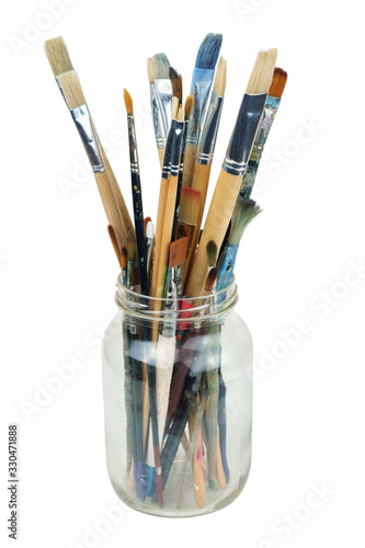 Various professional paint brushes in the transparent jar