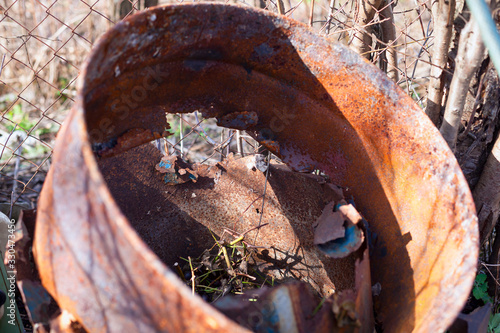 Closeup of old rusty metal barrel outdoors