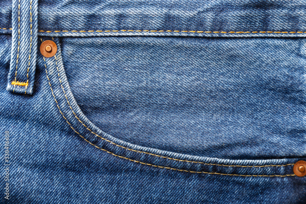 Blue jeans with front pocket and seams close up view. Top macro view Blue jeans with front pocket and seams close up view. Top macro view