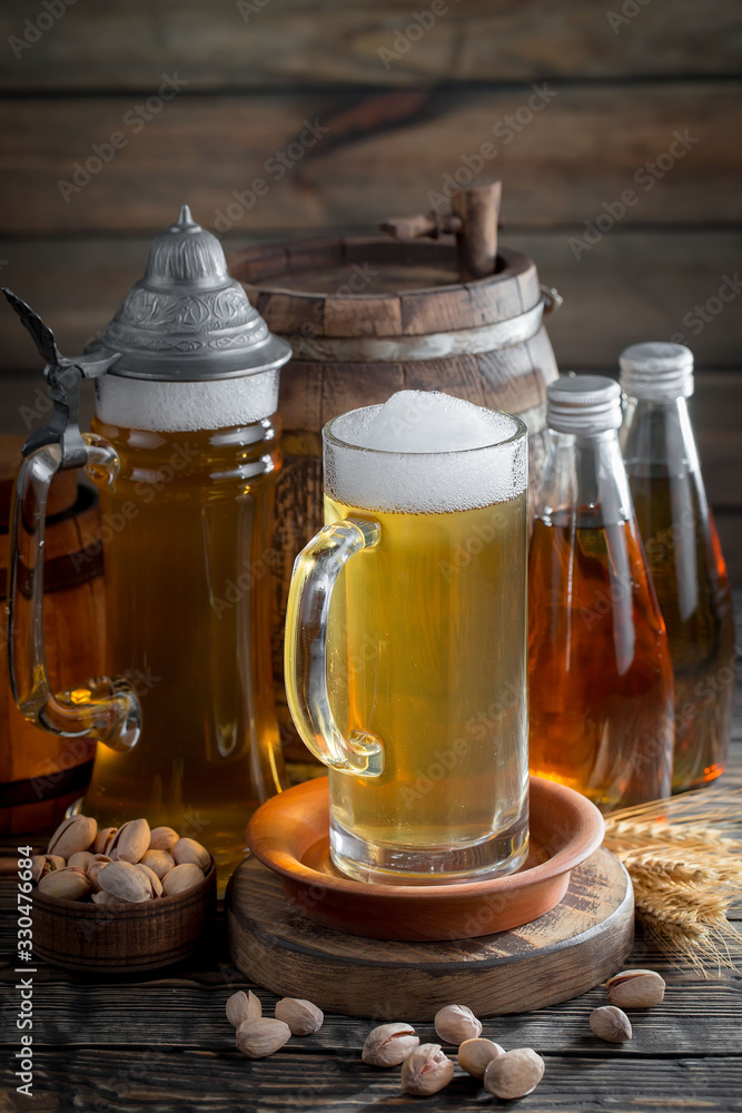 Light beer in a glass, on an old background. Light beer in a glass, on an old background.
