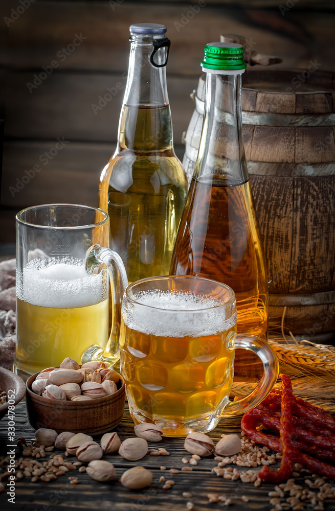Light frothing beer in a glass, on an old background. Light frothing beer in a glass, on an old background.