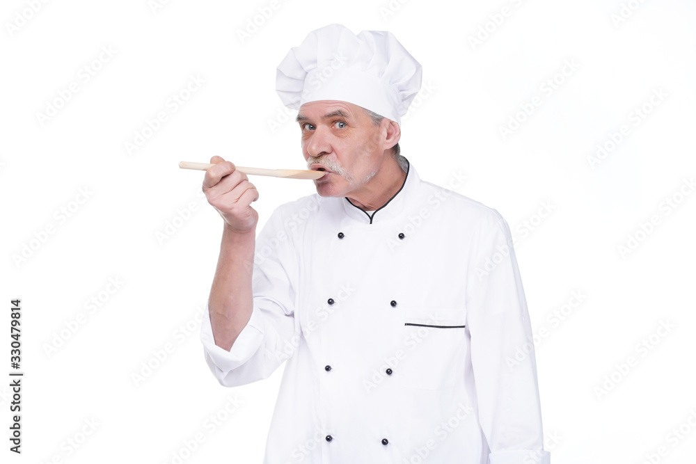 Male chef in uniform holding wooden spoon on white background Male chef in uniform holding wooden spoon on white background