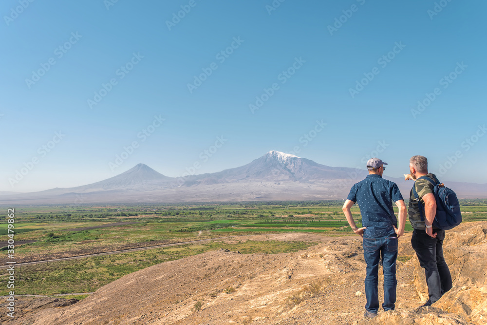 Panorama of Ararat with two male standing and looking to a valley