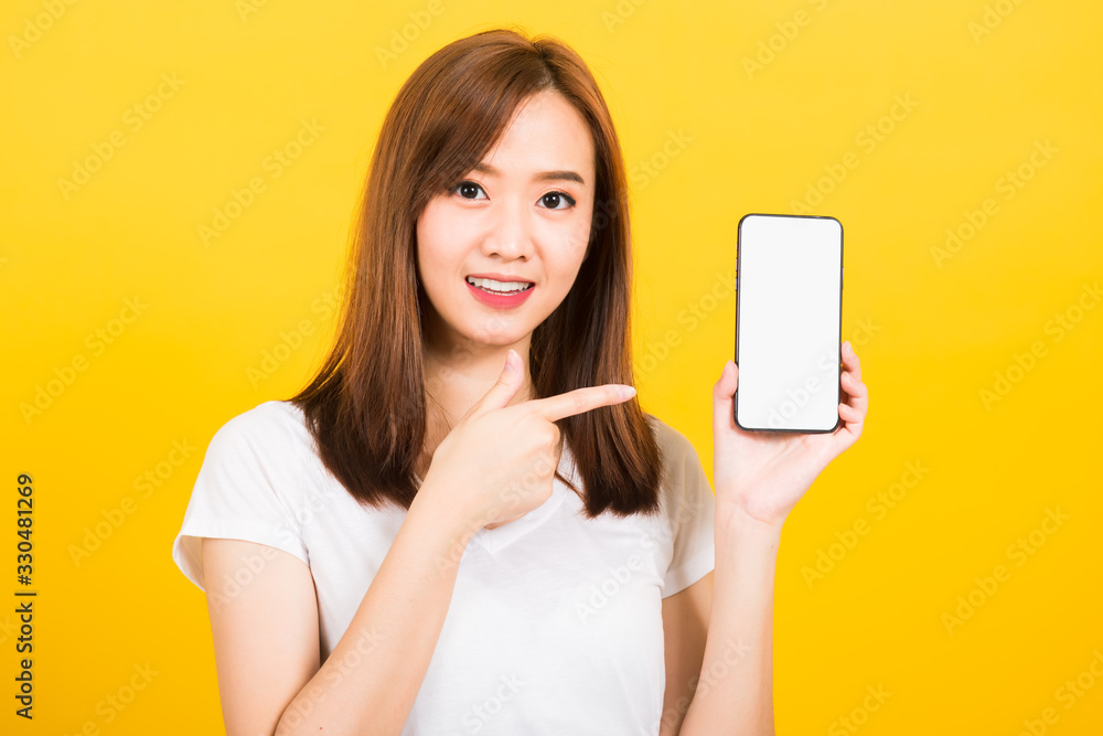 woman smile standing wear t-shirt making finger pointing on smartphone blank screen woman smile standing wear t-shirt making finger pointing on smartphone blank screen