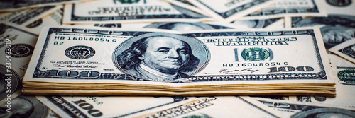 A pile of one hundred US banknotes. Cash of hundred dollar bills, dollar background image.