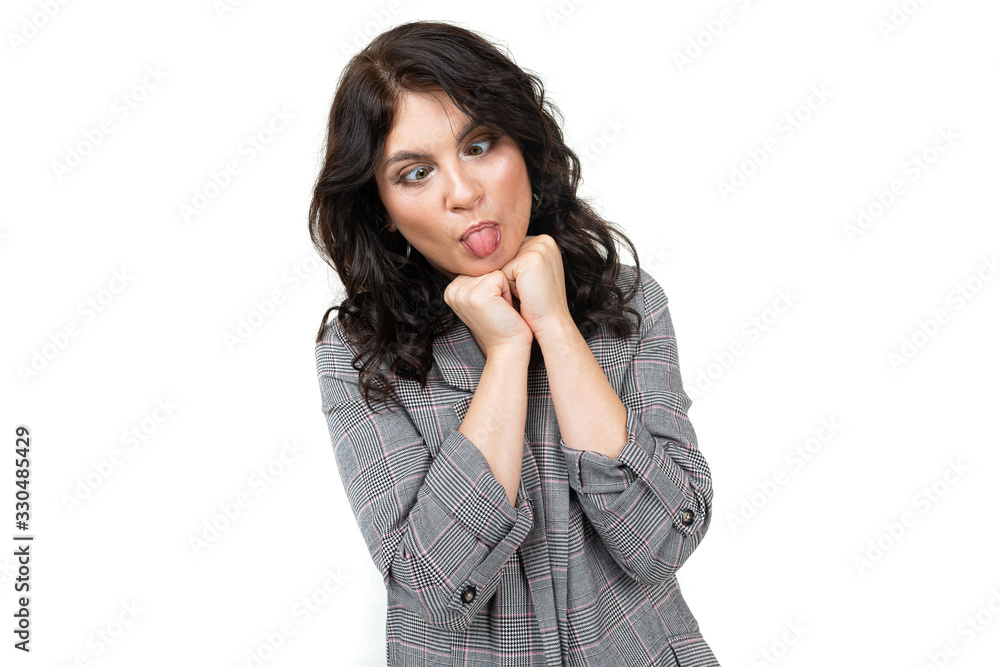 smiling cute girl in a classic plaid jacket grimaces on a white background smiling cute girl in a classic plaid jacket grimaces on a white background