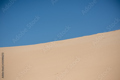 White sand with clear blue sky in background