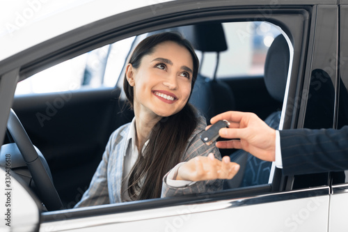 Businesswoman Taking Key From Seller For Test Drive