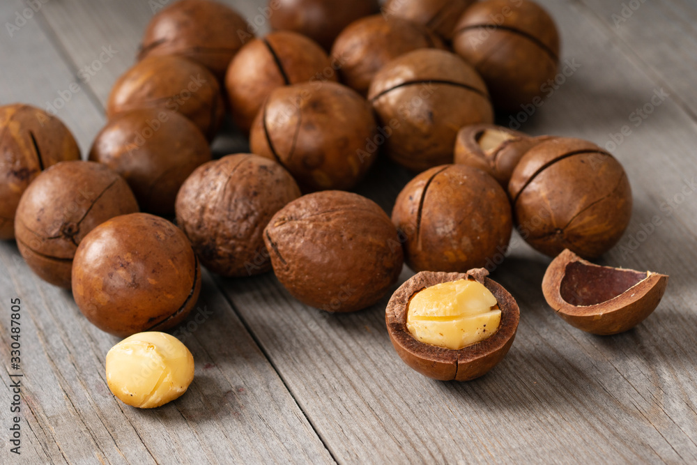 macadamia nuts on wooden table macadamia nuts on wooden table