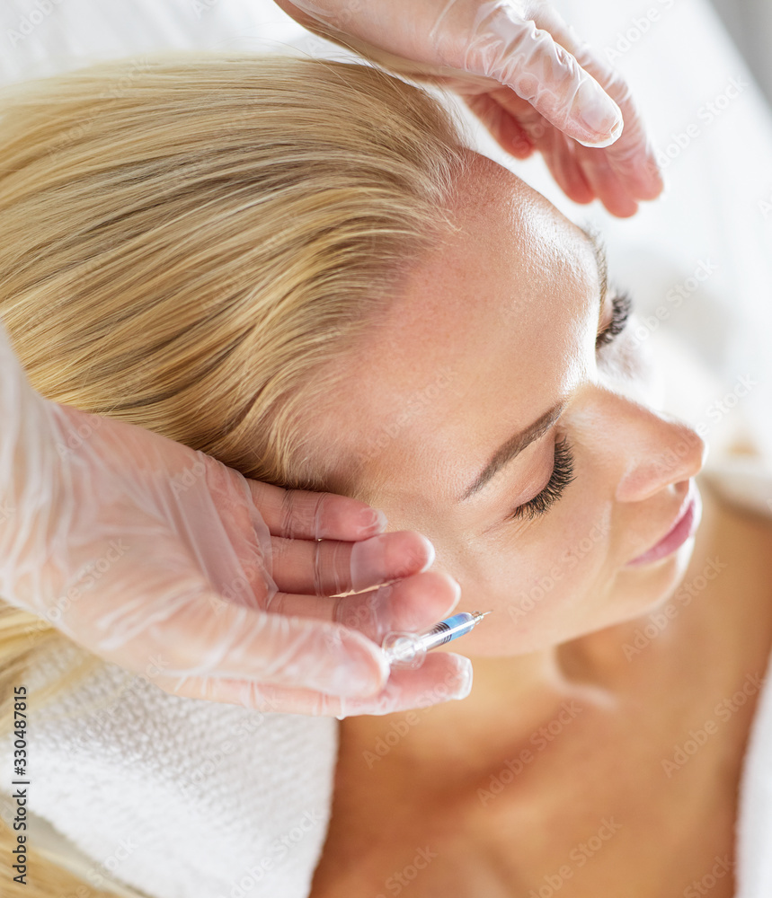 Beautiful woman gets beauty facial injections. Face aging injection. Aesthetic Cosmetology Beautiful woman gets beauty facial injections. Face aging injection. Aesthetic Cosmetology