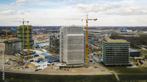 Fotografie, Obraz Construction site at the shore of almere haven in the netherlands
