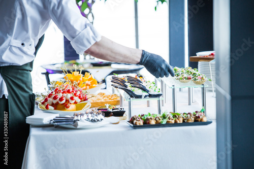 waiter makes the organization of snacks