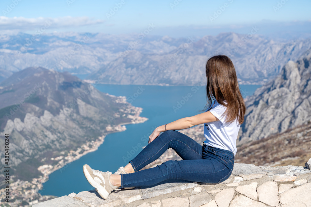 Young girl admiring the scenery from the viewpoint in Montenegro