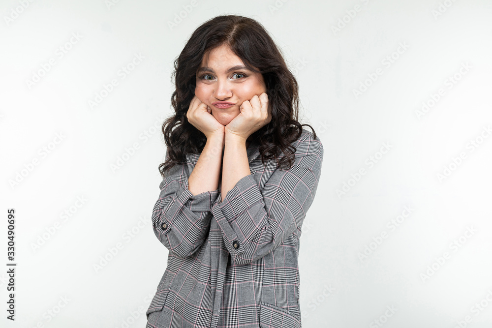 smiling modest girl in a classic checkered jacket on a white background with copy space smiling modest girl in a classic checkered jacket on a white background with copy space