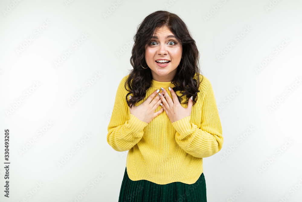 joyful happy brunette girl in a yellow sweater and green skirt on a white background joyful happy brunette girl in a yellow sweater and green skirt on a white background