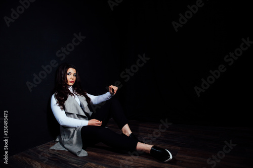 girl model posing in the Studio on a black background