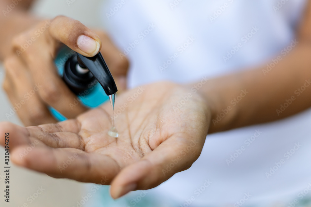 Closeup woman using alcohol gel hand sanitizer and protection against viruses and bacteria Closeup woman using alcohol gel hand sanitizer and protection against viruses and bacteria