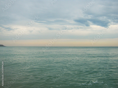 Seascape in cloudy or warm summer weather  surf wave. The concept of peace  tourism  excitement  relaxation and vacation.