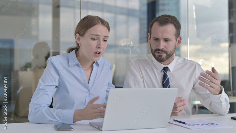 The Business people Shocked while Working on Laptop The Business people Shocked while Working on Laptop