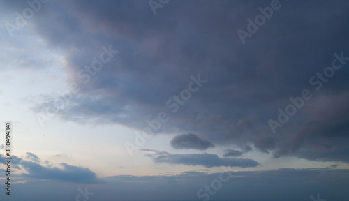 Beautiful sky with stretched clouds during twilight.