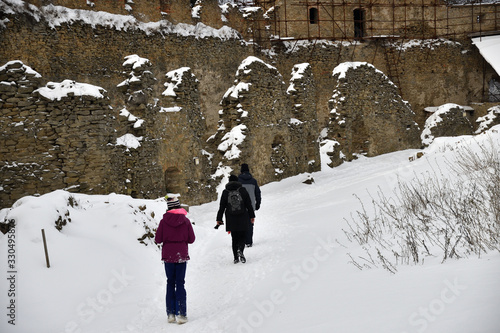 Family trip on castle ruins on the snow in winter Zborov Slovakia  photo