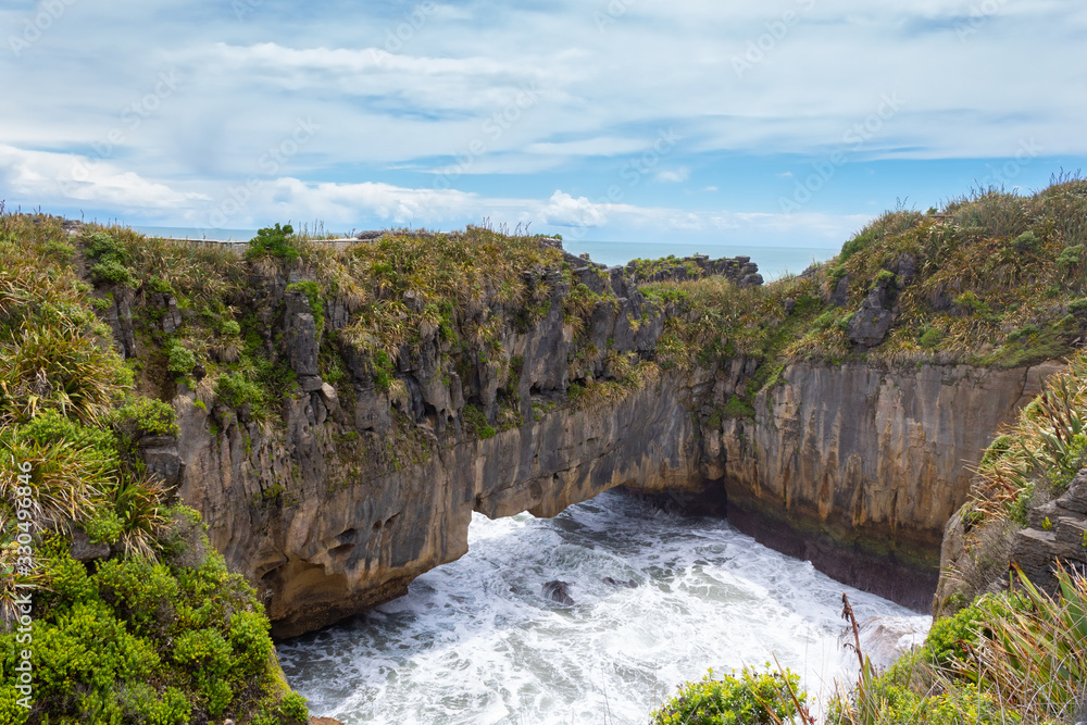 Blow hole in the pancake rocks, layers of eroded limestone, in Punakaiki, Paparoa National Park, South Island, New Zealand Blow hole in the pancake rocks, layers of eroded limestone, in Punakaiki, Paparoa National Park, South Island, New Zealand