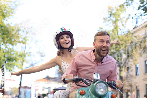 Young couple in love riding a motorbike. Riders enjoying themselves on trip. Adventure and vacations concept.