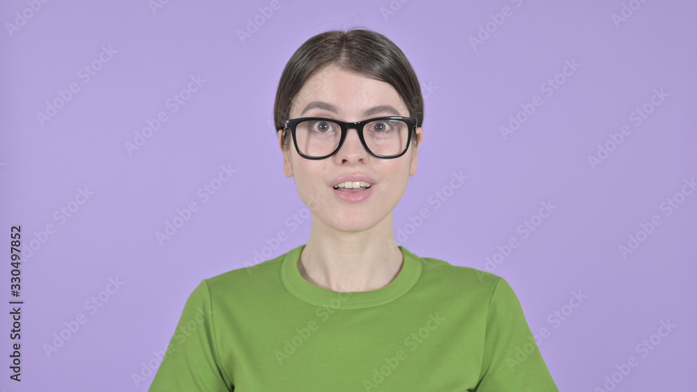 The Cheerful Woman saying Yes with Head sign on Purple Background