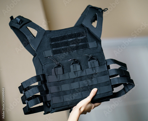 фотографія Body armor suit, Bulletproof vest for protection from bullets in the hand