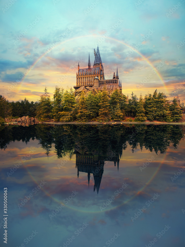 Fototapeta premium Hogwarts castle at Universal Studio Japan with impressive sky and rainbow