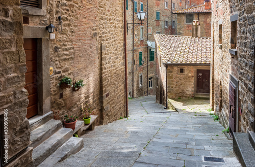 View with narrow picturesque medieval street of Tuscany old town Cortona  Italy