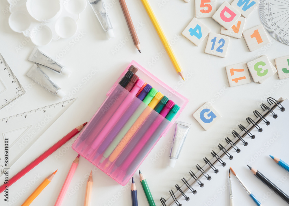 Back to school concept and artist kid concept with Drawing book, crayons, coloured pencils, Poster color and School stationery on white wooden background with copy space Back to school concept and artist kid concept with Drawing book, crayons, coloured pencils, Poster color and School stationery on white wooden background with copy space