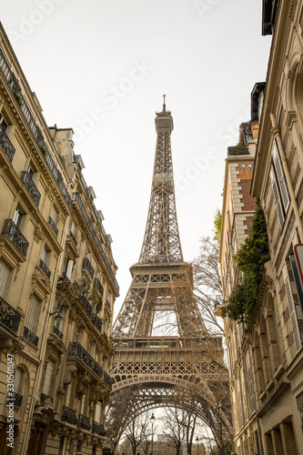 Street with view on the famous paris eiffel tower . © suprunvitaly