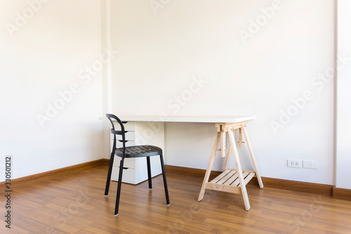 working space with wood table and chair in white empty room. Interior space.