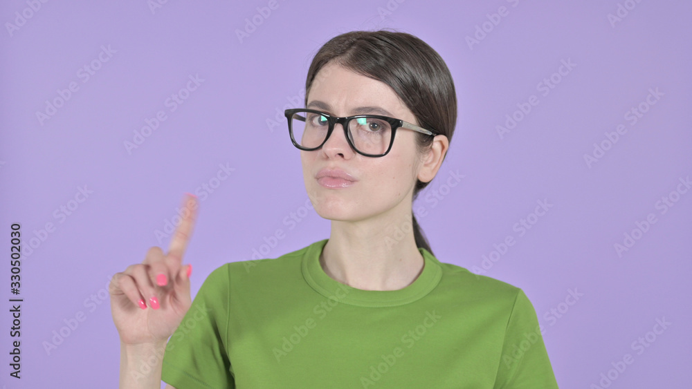 The Young Woman saying No with Finger on Purple Background