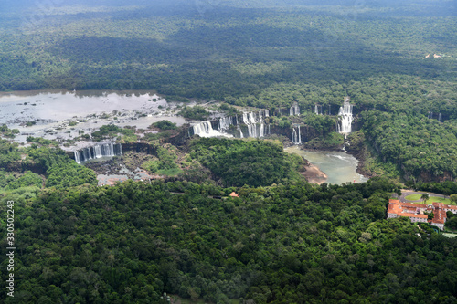 roaring waterfalls in the wild jungle from a helicopter