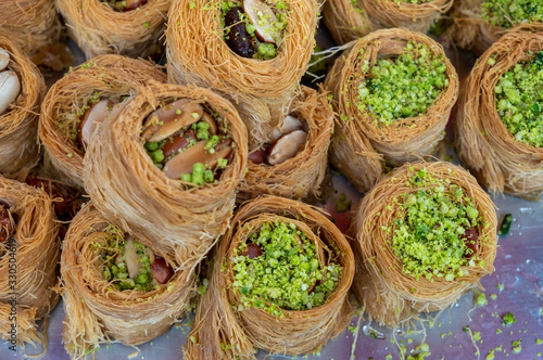 Traditional arabic and turkish sweets pastry dessert kadaif  kunafa  baklava   with pistachio  sold at local market