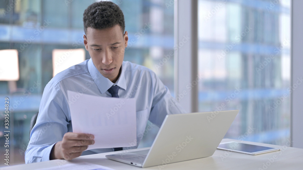 The African Businessman Reading Document in Office The African Businessman Reading Document in Office