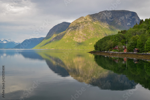 Mandalen  Norway  . Beautiful coastline of Western Norway  along Romsdalsfjord. Cloudy sky  just after the rain forming magical reflections and rainbows.