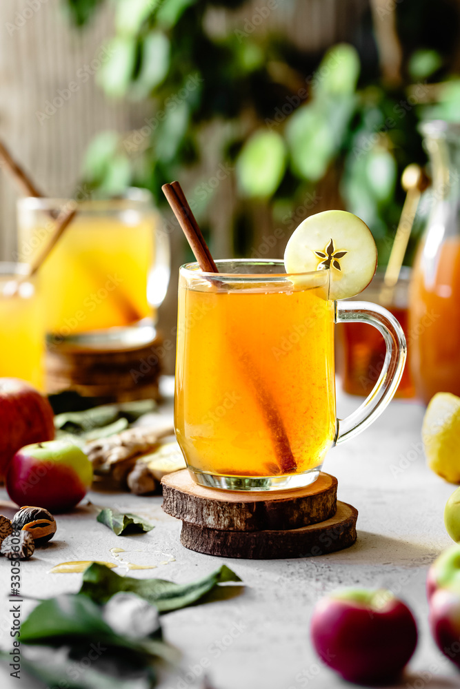 Hot apple cider in glass mugs in bright sunlight Hot apple cider in glass mugs in bright sunlight