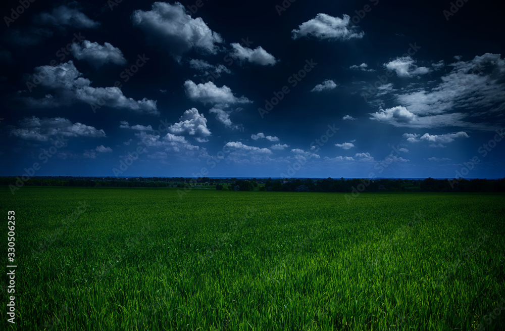 dark stormy sky and green field - natural summer landscape dark stormy sky and green field - natural summer landscape