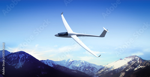 The glider is flying in the mountains photo