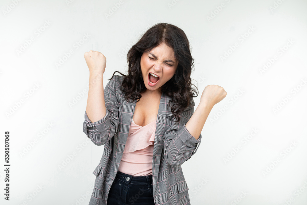 joyful winner in a gray checkered jacket on a white studio background joyful winner in a gray checkered jacket on a white studio background
