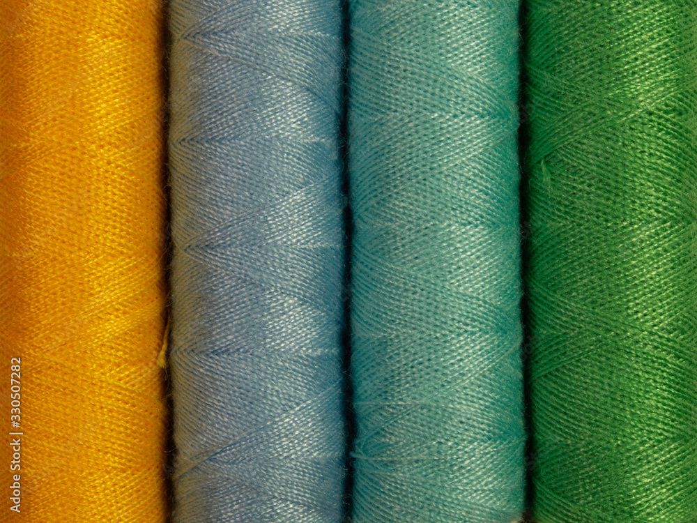 Set of multi-hue thread bobbins. Set of multi-hue thread bobbins.