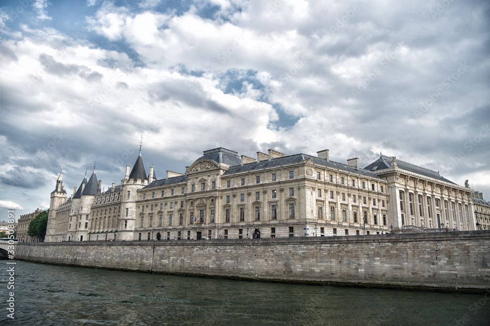 Place of interest. Palace at embankment. Palace building river view. Old palace in paris france. Palace residence on cloudy sky. Architecture and structure. Historical monument. Travel destination