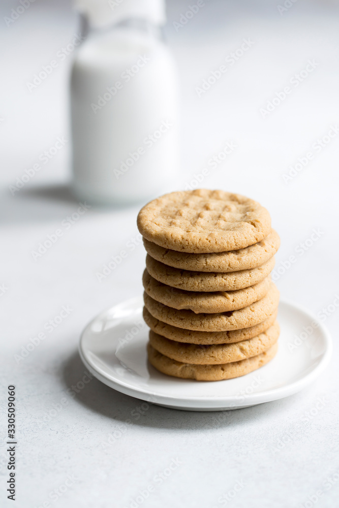 Peanut butter cookies stacked on a small plate. Peanut butter cookies stacked on a small plate.