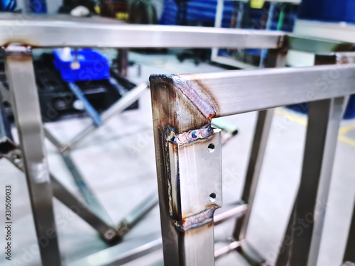 Close-up Welded Stainless Steel Square Tube Frame and Plate with Selective Focus